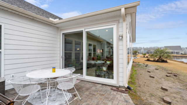 Bright custom sunroom with floor-to-ceiling windows, designed as a comfortable indoor-outdoor living space filled with natural light