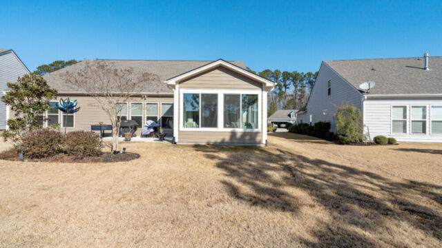 Bright custom sunroom with floor-to-ceiling windows, designed as a comfortable indoor-outdoor living space filled with natural light