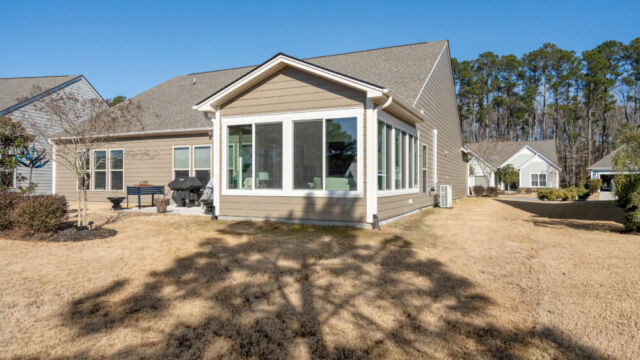 Bright custom sunroom with floor-to-ceiling windows, designed as a comfortable indoor-outdoor living space filled with natural light